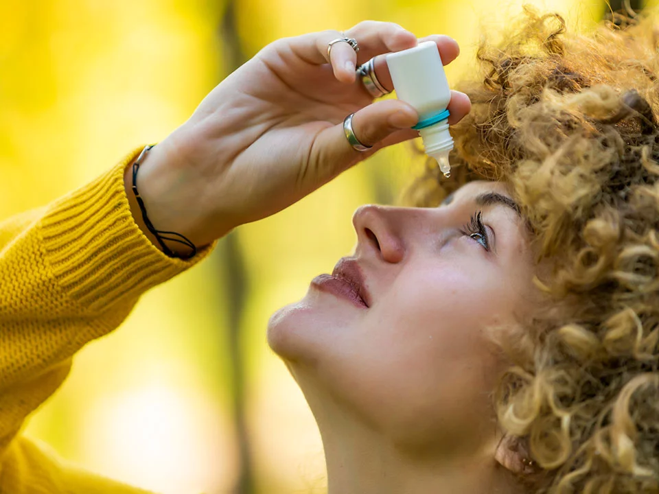 Woman Uses Eye Drops for Eye Treatment